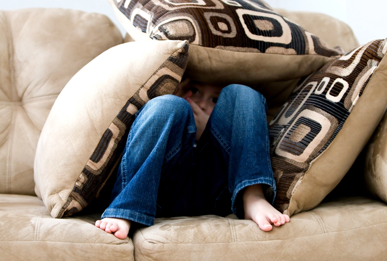 Child hiding the couch cushions